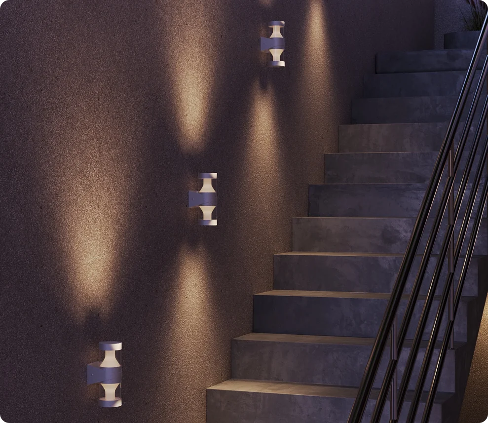 Surface mounted wall luminaires along a staircase